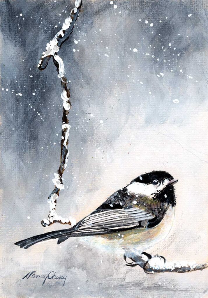 Black-capped chickadee on snowy branch